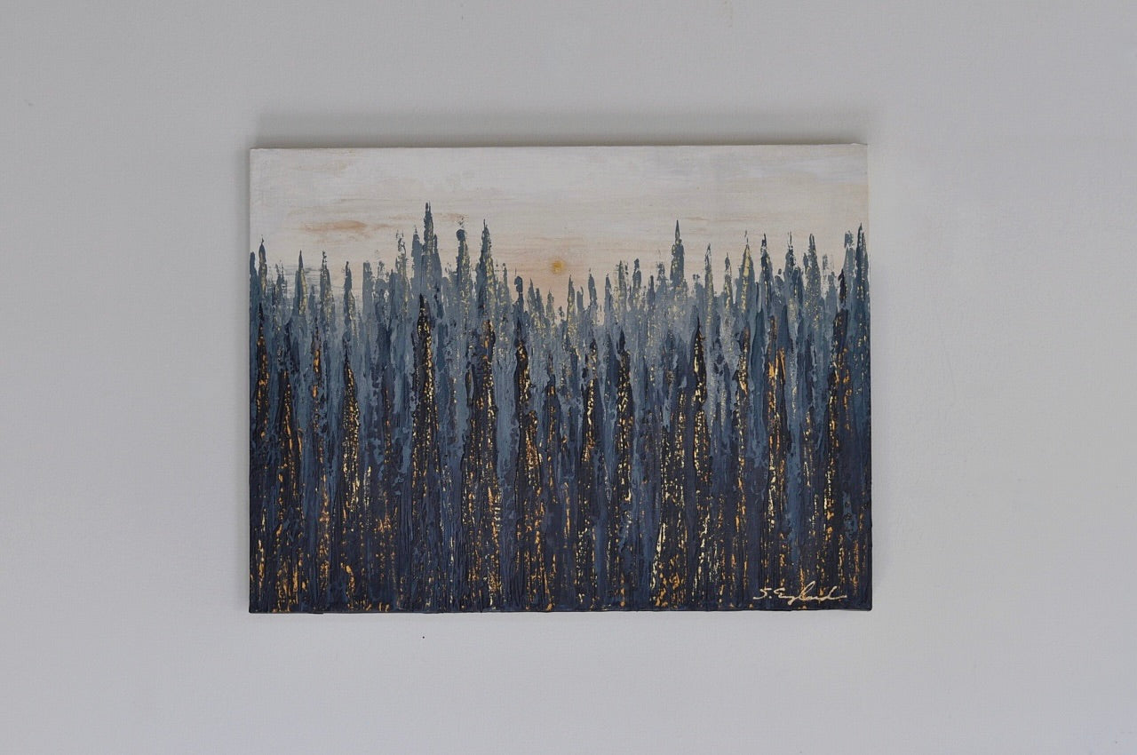 Modern tree landscape in deep blues and light blues with the golden highlights create a vibe of sunset.