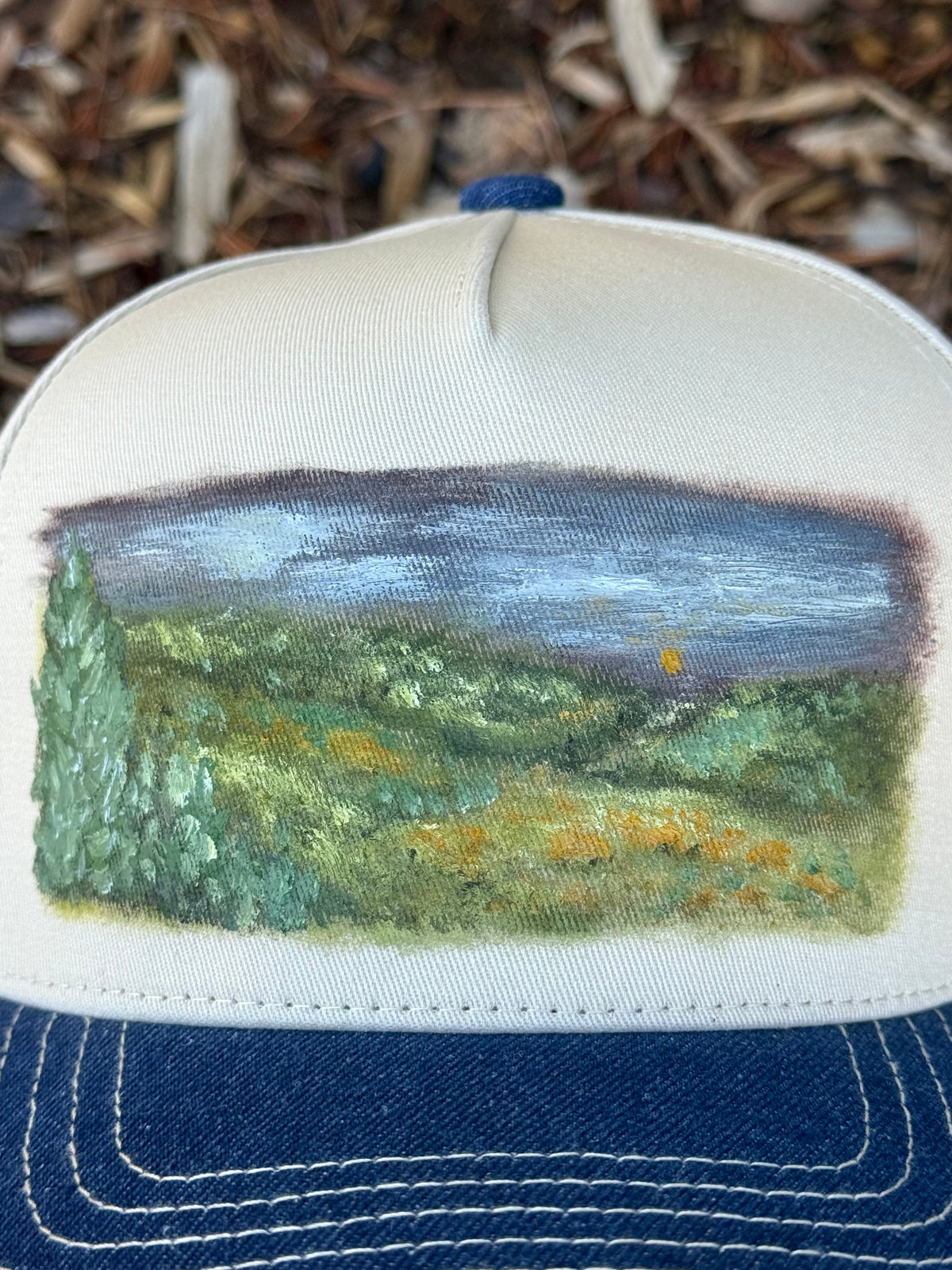 Hand painted wearable art painted on cream/denim blue baseball cap - landscape