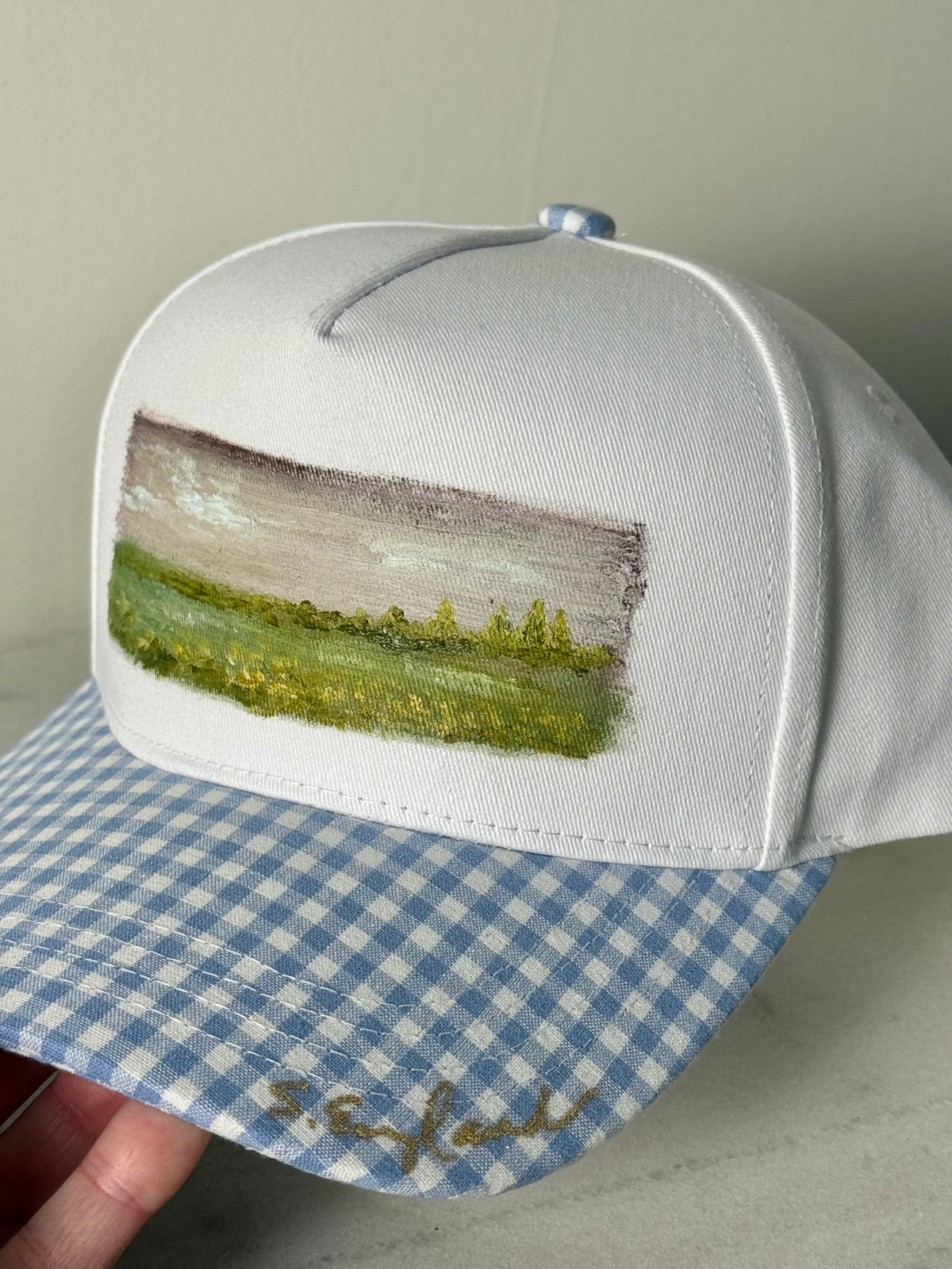 Hand painted wearable art painted on white canvas hat with white and blue gingham brim -landscape