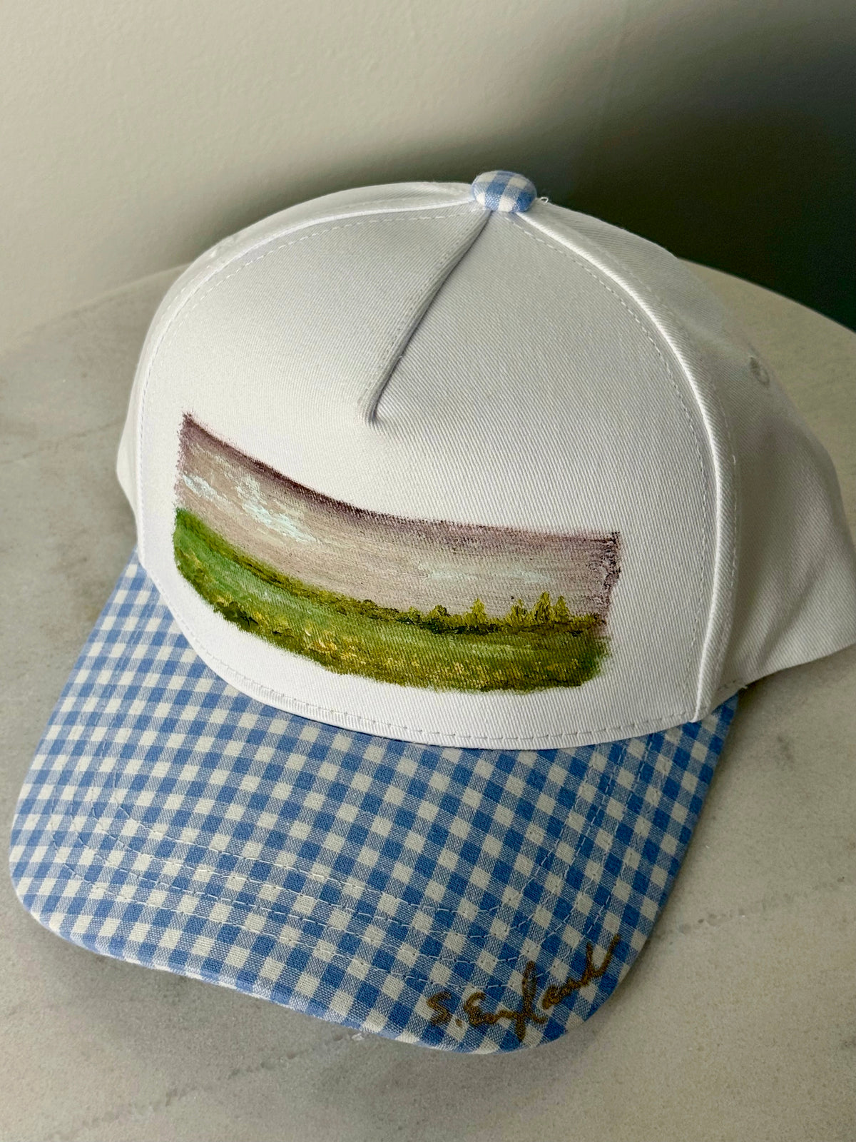 Hand painted wearable art painted on white canvas hat with white and blue gingham brim -landscape