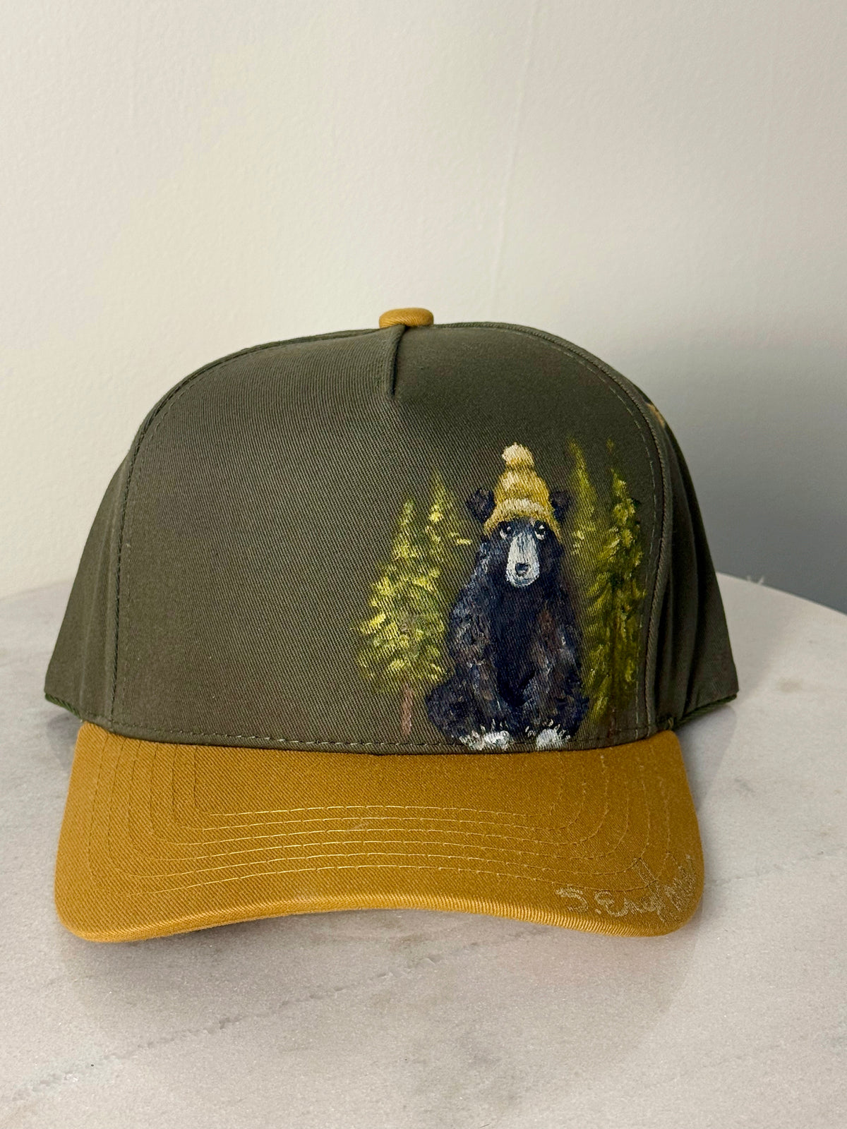 Hand painted wearable art on green canvas baseball hat with yellow brim - black bear