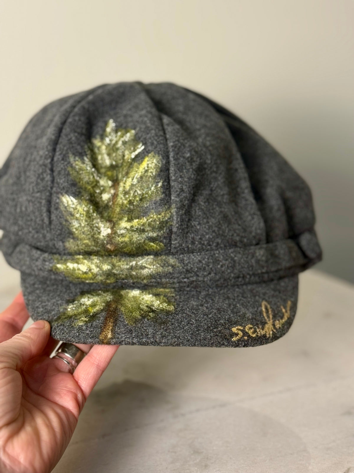 Hand painted wearable art on soft dark grey polyester newsboy cap - lone tree
