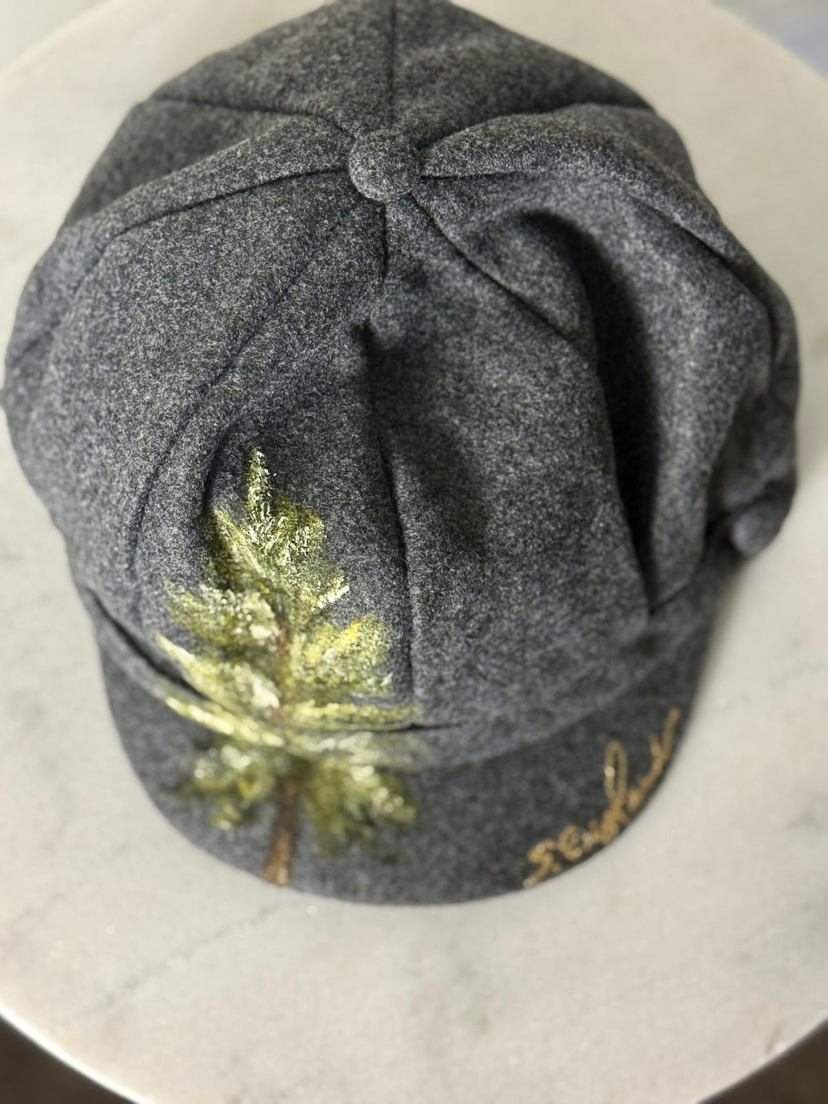 Hand painted wearable art on soft dark grey polyester newsboy cap - lone tree