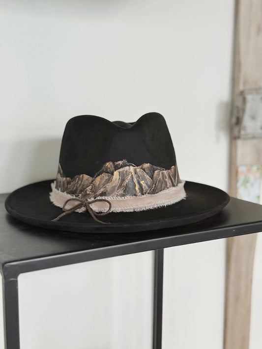 Tip your hat in style with this hand painted black vegan suede rancher hat