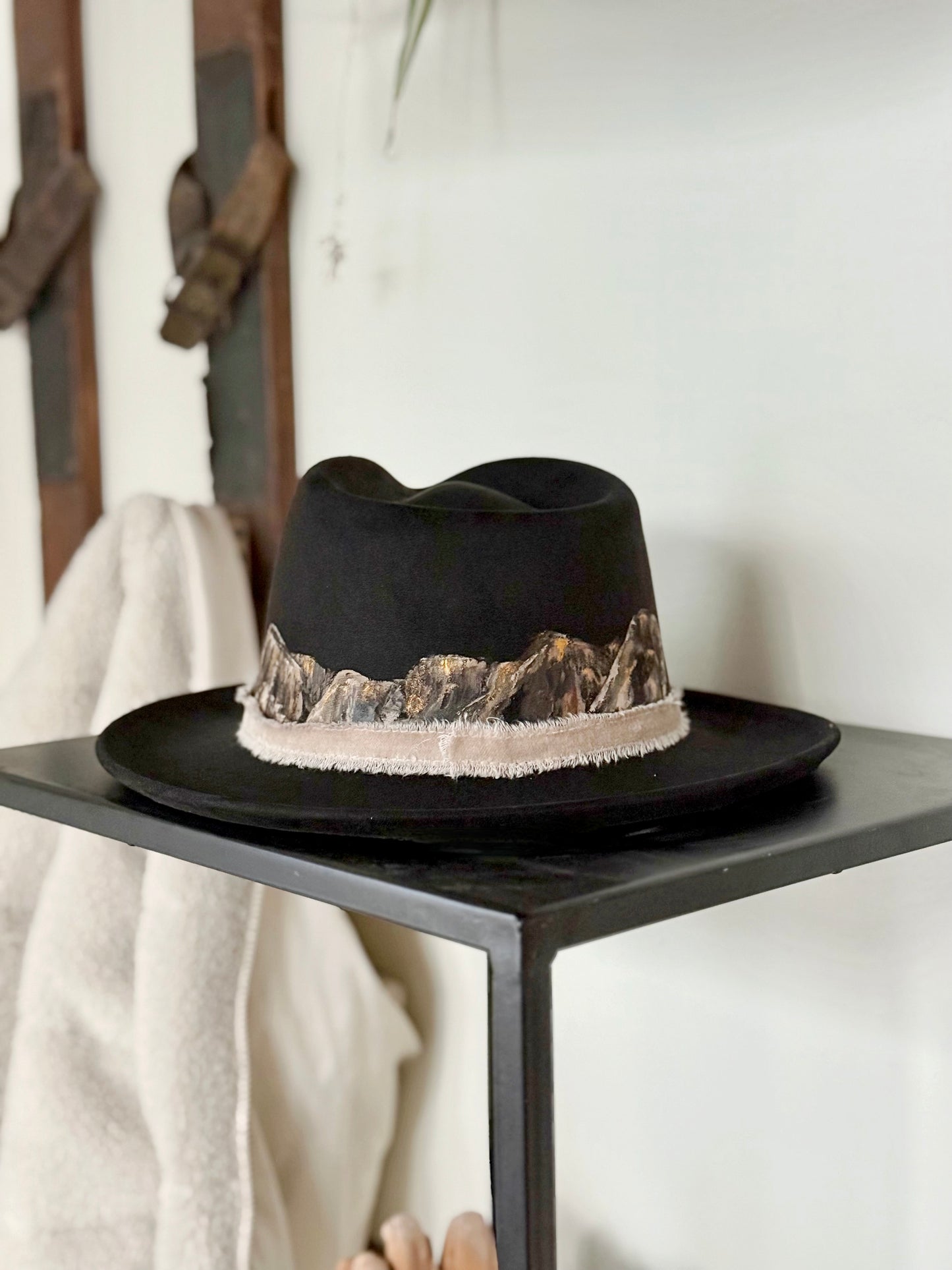 Tip your hat in style with this hand painted black vegan suede rancher hat
