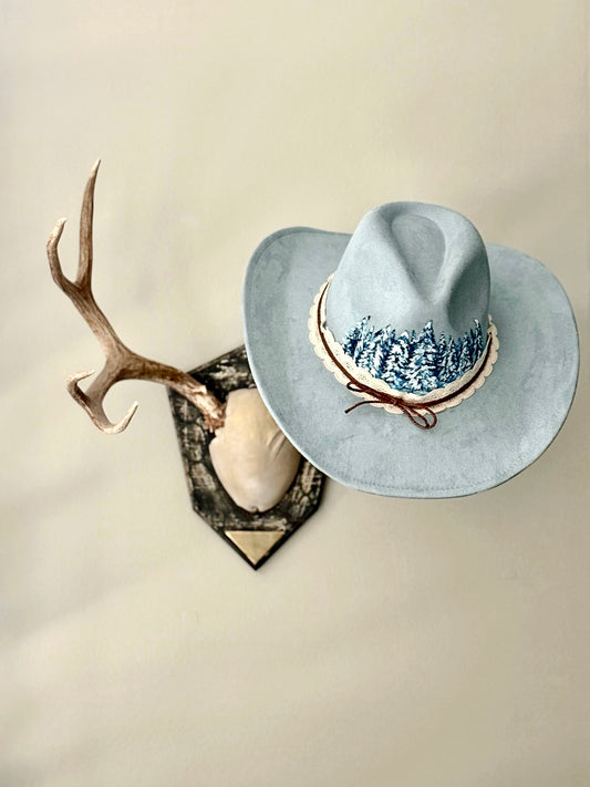 Elevate your style in this soft blue vegan suede hat - hand painted