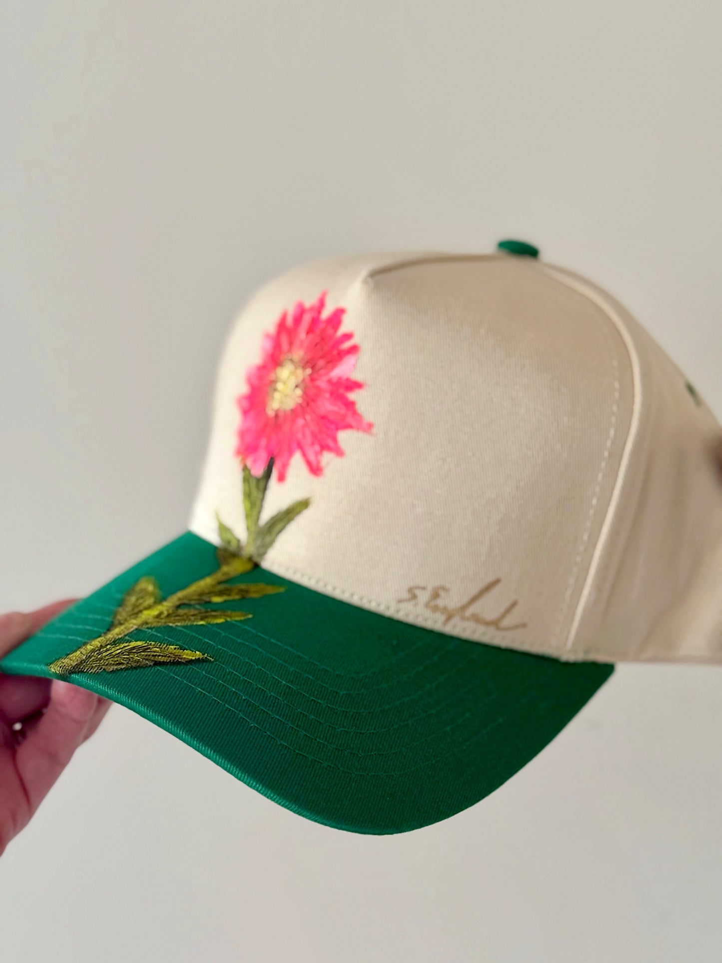 be pretty in pink in this hand painted CC cream and green trucker hat