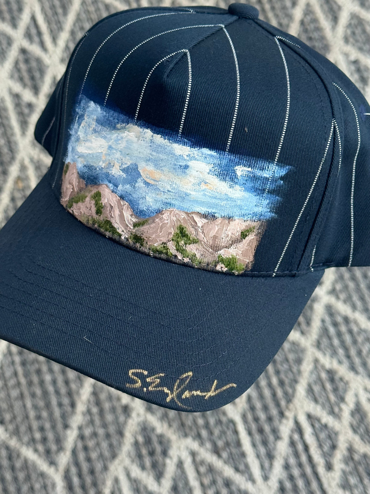 Hand painted wearable art that is washable- mountains scene on blue/white stripe ball cap