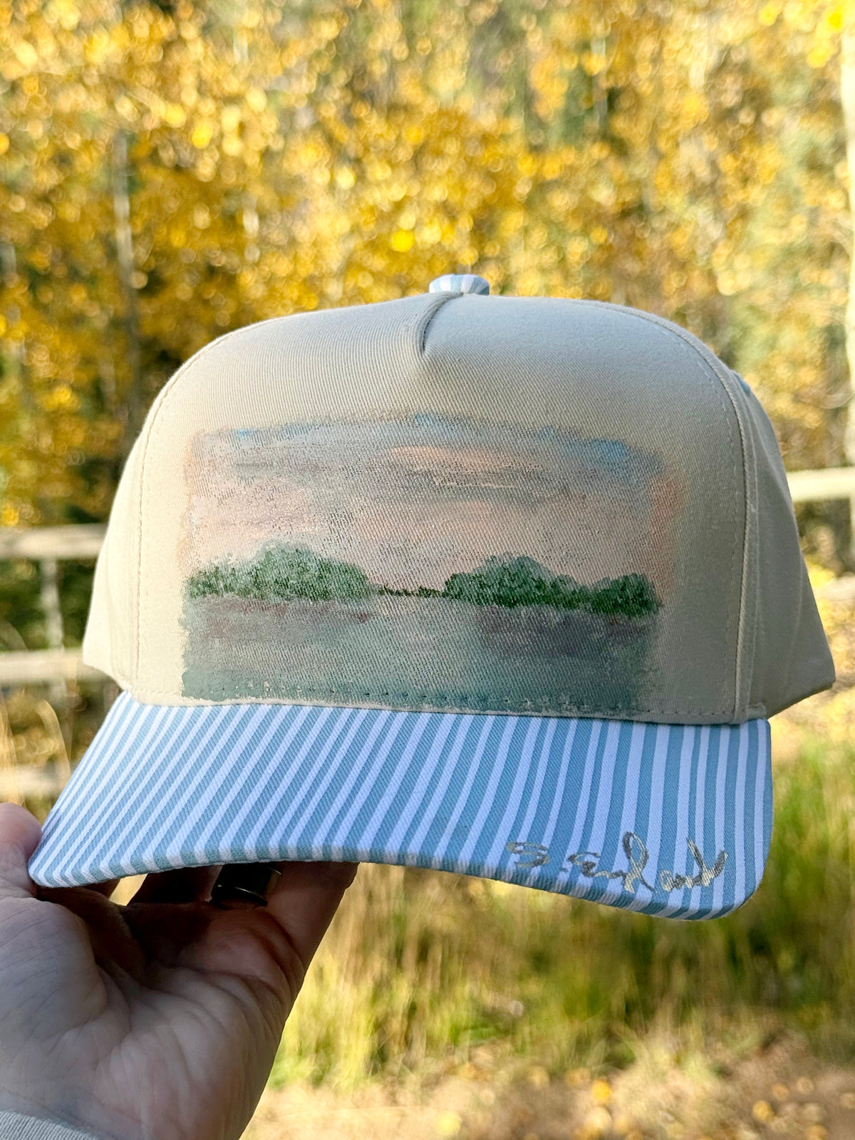 Hand painted landscape scene on cream and blue canvas hat