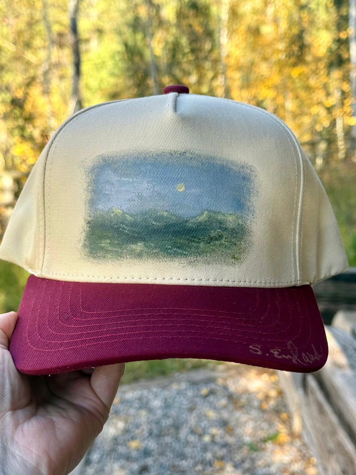 Hand painted landscape scene painted on cream/burgundy canvas baseball cap