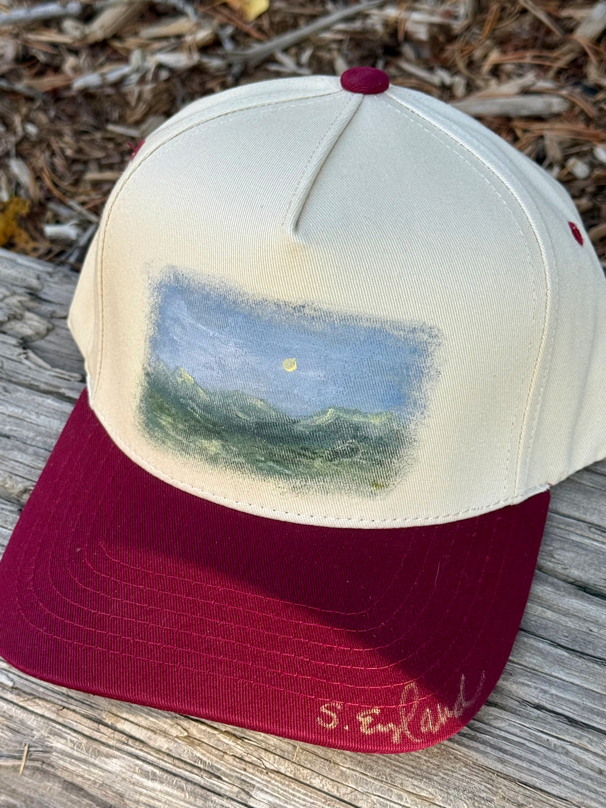 Hand painted landscape scene painted on cream/burgundy canvas baseball cap