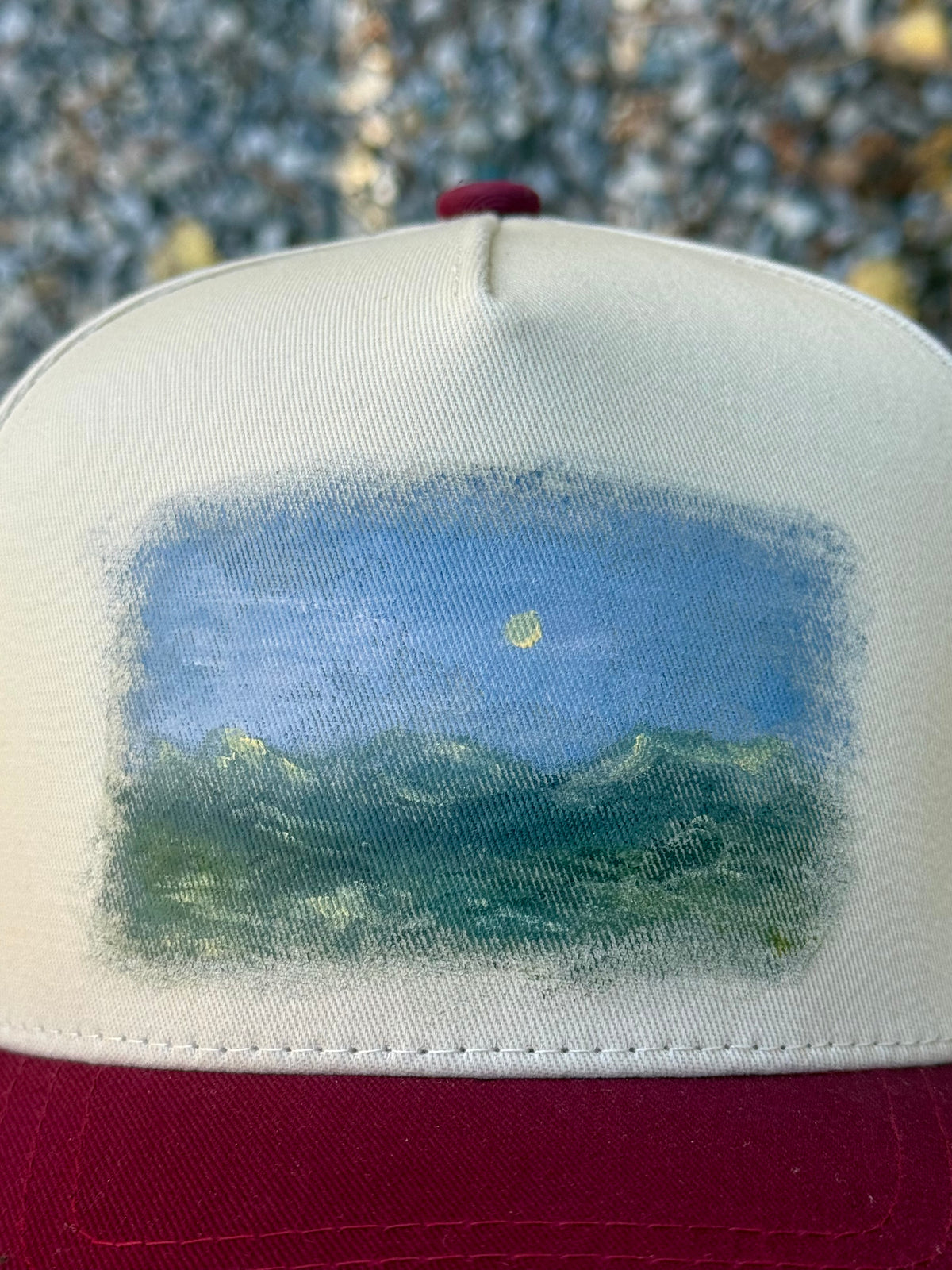 Hand painted landscape scene painted on cream/burgundy canvas baseball cap